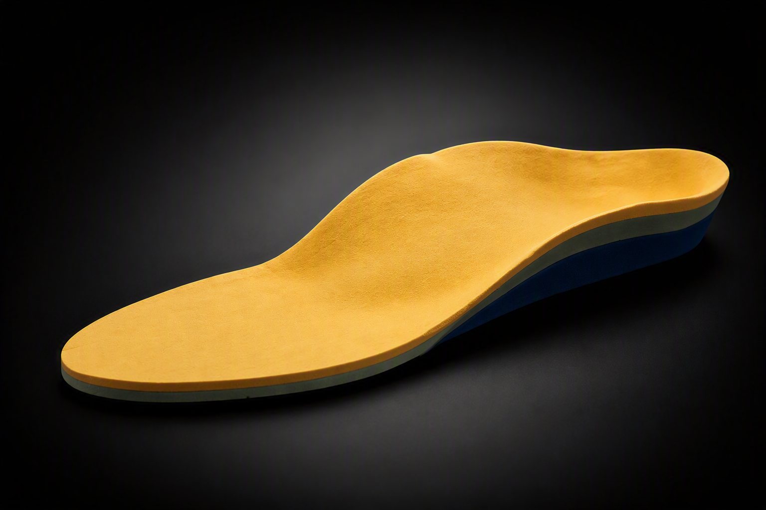 A dual-layer custom orthotic with a yellow top cover