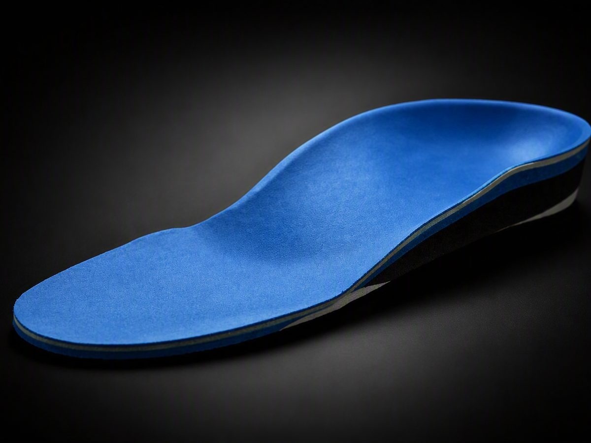 A custom orthotic shell with a contoured arch support